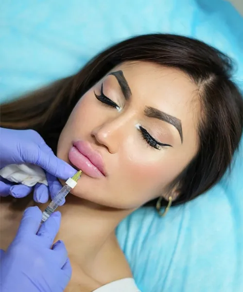 Young woman receiving lip filler injection for fuller lips at aesthetic clinic